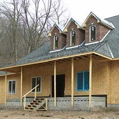 orange brick home with gray roof